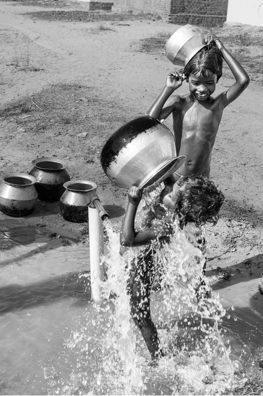 Water for Recreation and Enjoyment - enjoying a lavish bath and having fun with water on a hot afternoon in Nellore district, Andhra Pradesh